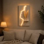 That's a beautiful piece — a glowing face silhouette LED wall art with a mini shelf and pampas grass. Very on-trend for home decor! - Image 3