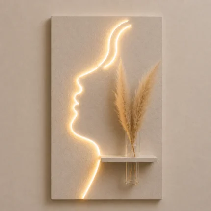 That's a beautiful piece — a glowing face silhouette LED wall art with a mini shelf and pampas grass. Very on-trend for home decor!